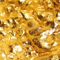 Bellatrix - superficie irregular cubierta de lámina dorada