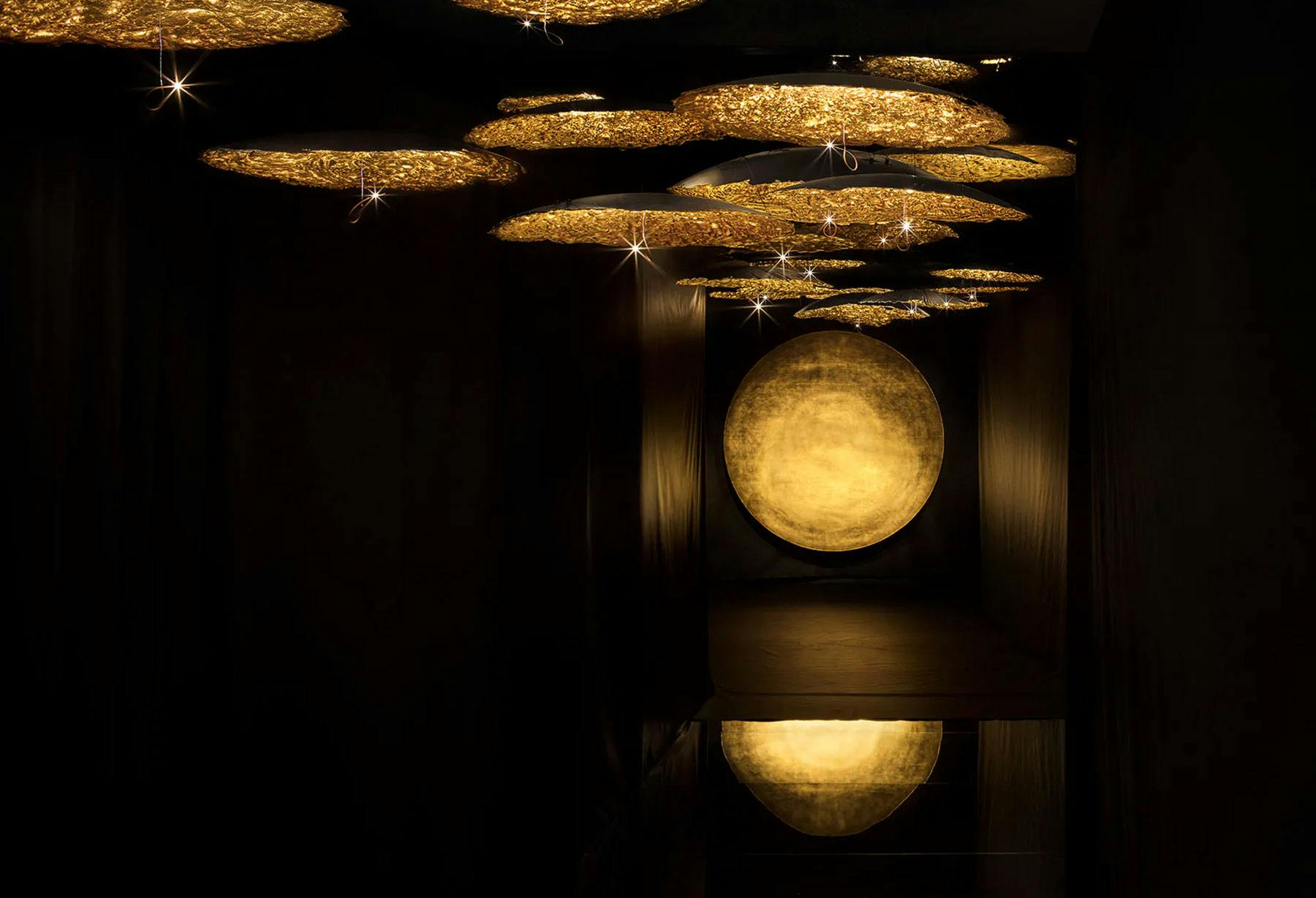 <p>“Resonance” by Enzo Catellani is an emotional and immersive walk through lights and sounds, created by more than 50 discs of different size covered in gold coloured leaf and lit by micro LEDs, hanging at different heights. With this project for the Fuori Salone in Milan, Enzo Catellani creates a clever balance of music, light and shade: a fascinating atmosphere that fills the eyes of visitors with wonder and leads them in discovery of light, in a “new light”.</p>

